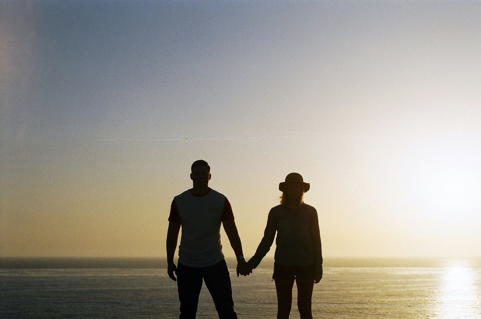 Silhouette of a couple holding hands