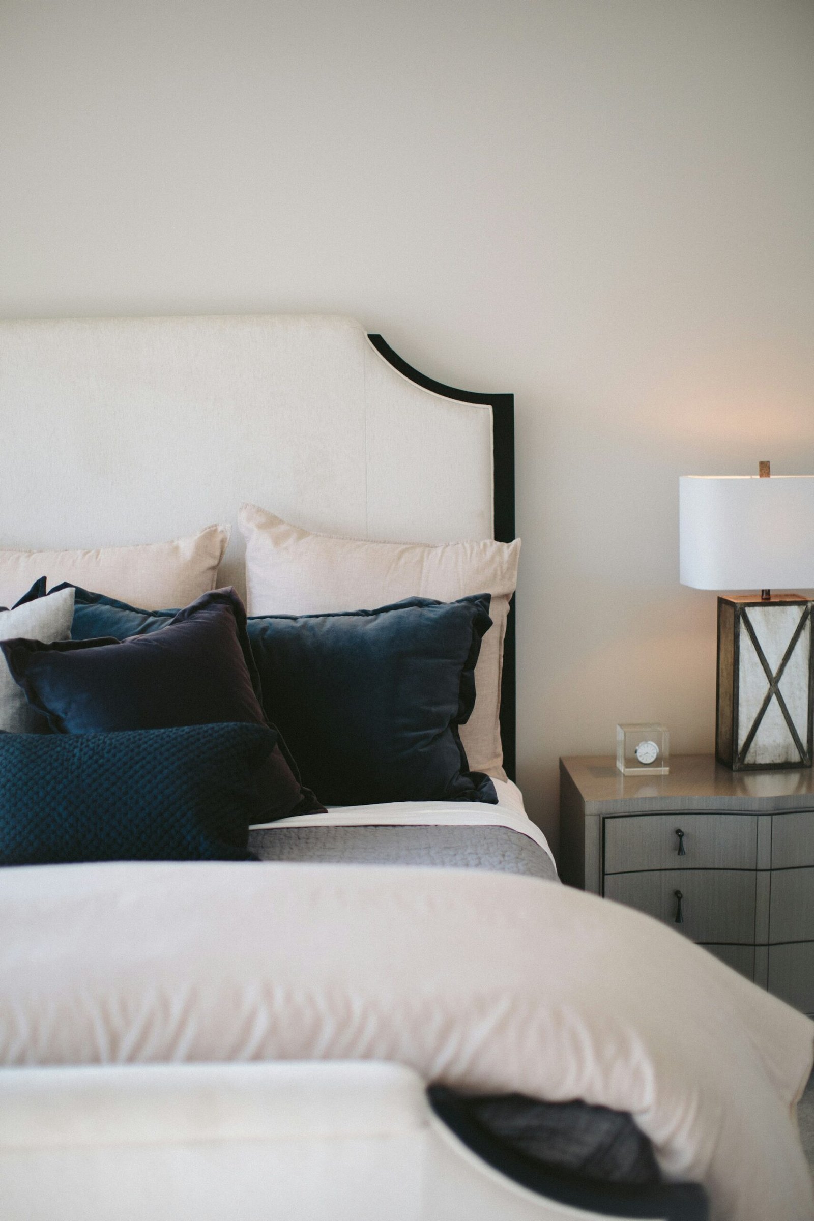 Neutral toned bedroom with black and white pillows